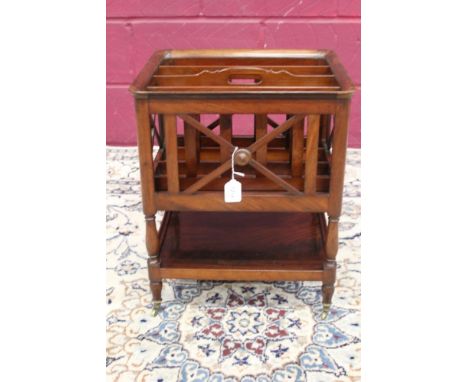 19th century mahogany Canterbury in the Empire style, with slatted divisions and X-ornament, having shelf below, on brass cap