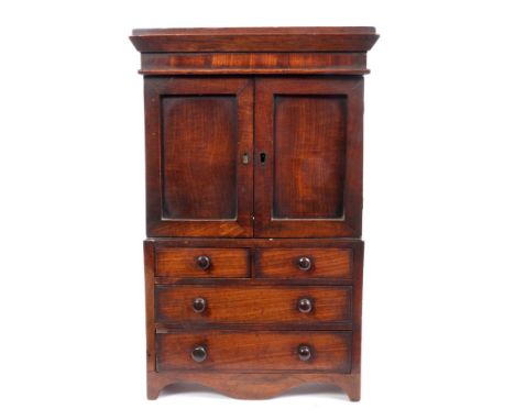Victorian mahogany miniature press on chest with two panelled doors, two short and two long drawers with brass handles, on br