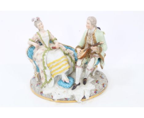 Late 19th century Dresden porcelain Romantic figure group of a seated lady listening to her beau playing a mandolin with a po