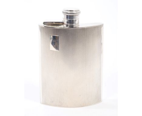 Late 1940s silver spirit flask of shaped form, with engine-turned decoration, vacant cartouche and hinged bayonet fastening c