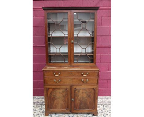 George III mahogany secretaire bookcase with dentil cornice and adjustable shelves enclosed by pair of astragal glazed doors,