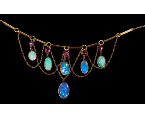 Edwardian opal and ruby fringe necklace with six graduated oval cabochon opals suspended from five circular mixed cut rubies 