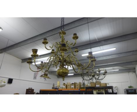 Dutch style brass light fitting with four branches to the top tier above eight longer branches