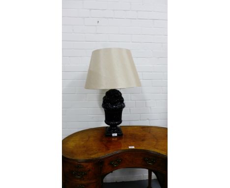 A black glazed fruit moulded ceramic table lamp base with cappucino coloured shade 