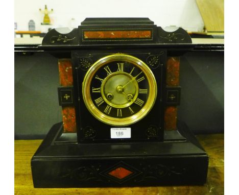 Victorian black slate mantle clock with red hardstone inserts, the brass chapter ring with Roman numerals 