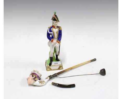 Continental pipe, the bowl modelled as a porcelain head, together with figure of an army officer (A/F) (2) 