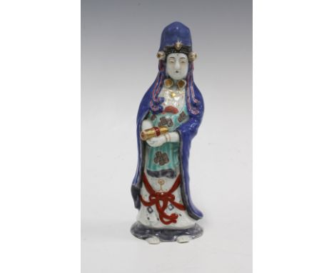 Arita figure of Kannon, modelled standing wearing a powder blue cloak, 20cm high. 