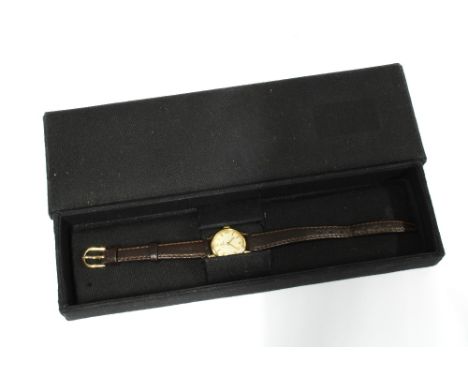 OMEGA, ladies vintage wristwatch, circular champagne dial with quarter numerals and hour batons, on a brown leather strap 