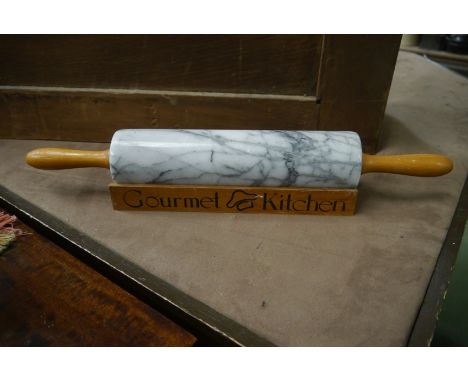A Gourmet Kitchen marble rolling pin with wooden stand 