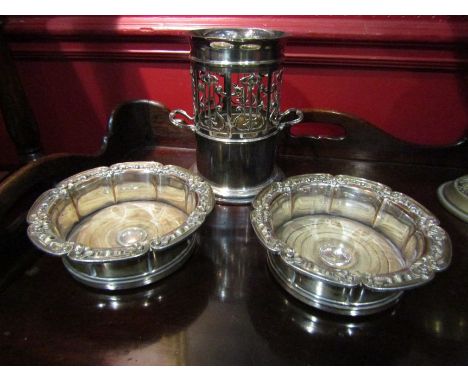 An Art Nouveau silver plate wine bottle holder and a pair of coasters