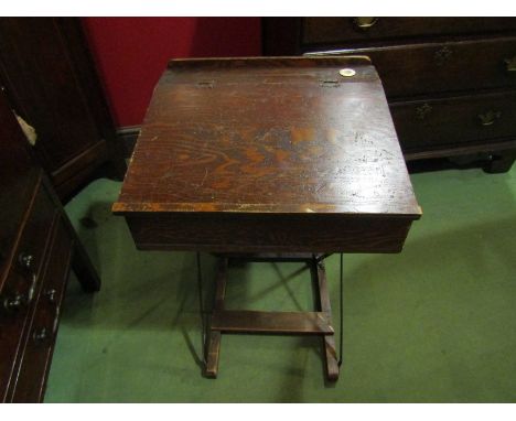 A late 19th/early 20th Century free-standing collapsible child's school desk with original ceramic inkwell