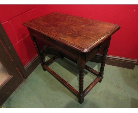 An oak hall table the single end frieze drawer over bobbin turned supports joined by stretchers, 64cm x 75cm x 40cm