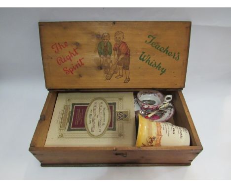 A Whisky box containing mostly Royal Commemorative items including silver spoon, Royal Doulton jug, boxed set of badges etc