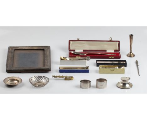 A collection of hallmarked silver ware, to include a pierced dish, a paten, an inkwell, two napkin rings, a weighted bud vase