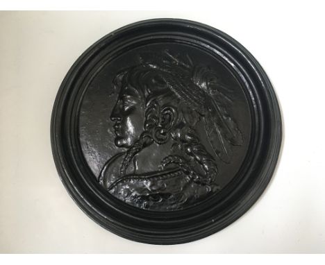 A black painted terracotta round wall plaque depicting Native American profile portrait, diameter 36cm. IMPORTANT: Online vie