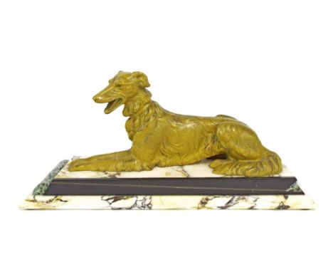 Art Deco cold painted cast bronze figure of a recumbent hound, upon a stepped rectangular marble base, 18.5" long x 9" high