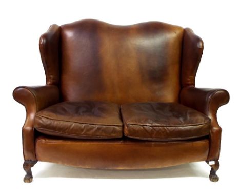 Georgian style good quality studded leather wing back two seater sofa on claw and ball feet, 57" long