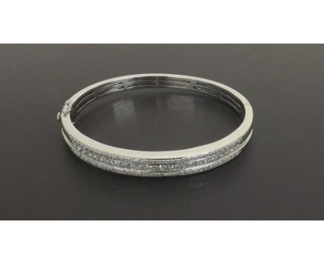 (867 540217-1-a) 18ct white gold brilliant and princess-cut diamond hinged bangle, estimated 2.8ct approx in total, 35.7gm, 6