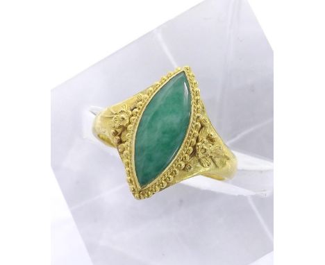 Chinese marquise shaped jade ring, the shoulders with floral decoration in yellow metal, stamped marks, 18mm, ring size K