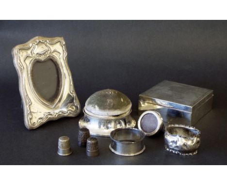 Mixed lot of small silver pieces to include a cigarette box with engine turned hinged lid, silver based pin cushion, three th