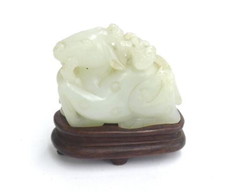 Carved jade of a recumbent deer upon a hardwood stand, 2.5" high