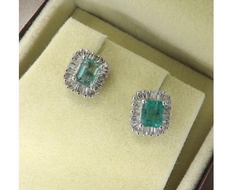 (31) Pair of attractive 18ct emerald and diamond cluster earrings, with single emeralds in a surround of baguette-cut diamond