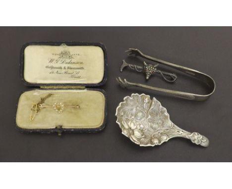 Victorian silver caddy spoon with embossed foliate decoration, Sheffield 1848, maker 'A.H', 3" long; small pair of EPNS tongs