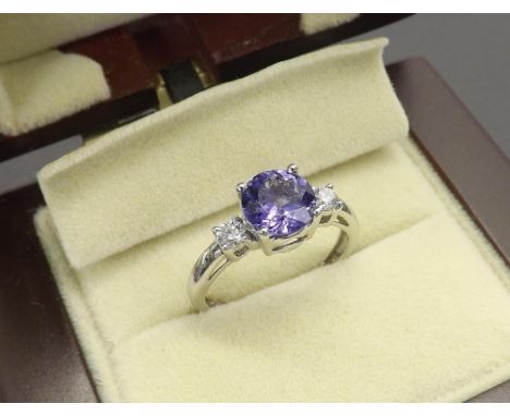 (32) 18ct tanzanite and diamond three stone ring, the tanzanite 1.20ct approx with two round brilliant-cut diamonds, 2.9gm, r