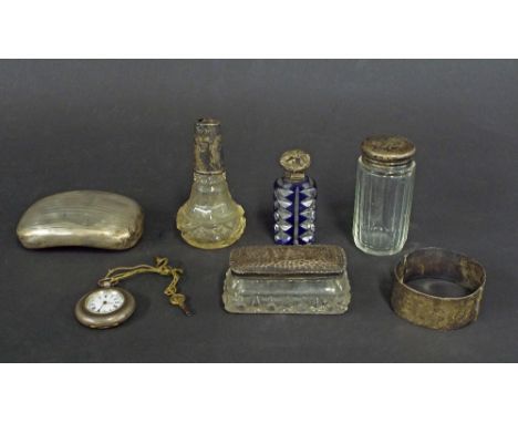 Mixed lot of silver to include a fob watch, engine turned hip shaped tobacco box, silver topped blue and clear glass scent bo