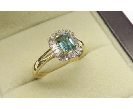 (24) 18ct yellow gold emerald and diamond cluster ring, the emerald within a surround of baguette-cut diamonds, cluster 9mm x