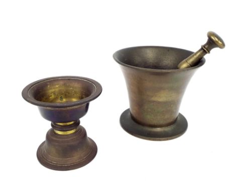 Antique cast brass pestle and mortar, the mortar 4.5" high: together with a further cast bronze and gilt stand, 4" high (3)