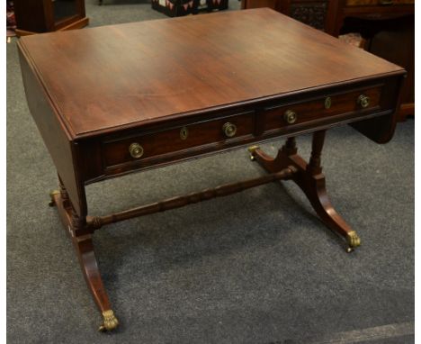 A George III mahogany sofa table of large proportions, two drawers for frieze, drum handles, blind drawers to verso, turned e