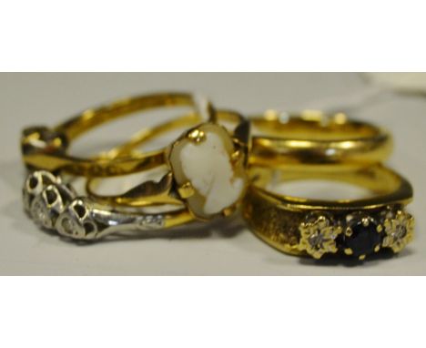An 18ct gold diamond trilogy ring, platinum setting in the form of three hearts 2g: a 9ct gold barrel shaped wedding band; a 