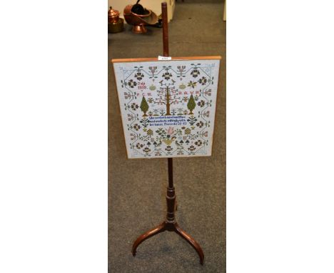 A Victorian mahogany pole screen, the sampler reproduced dated July 1999