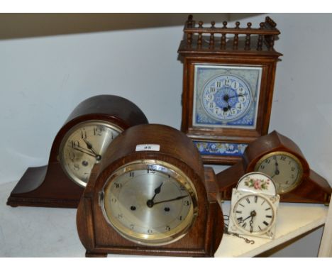 An oak mantel clock with ceramic dial, Arabic numerals; two Napoleon hat mantel clocks; an Enfield mantel clock; a novelty sm