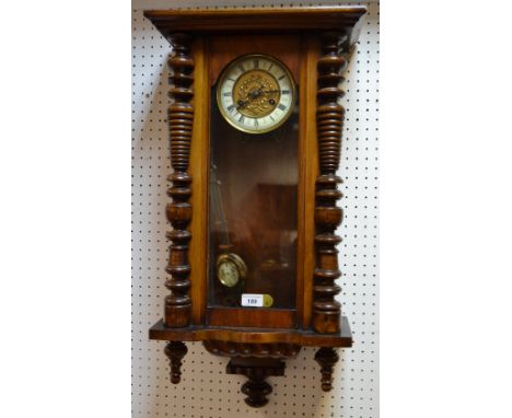 A 19th century Junghans walnut Vienna wall clock enamelled chapter ring, Roman numerals, glazed door flanked by turned pilast