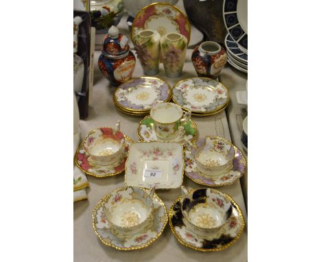 A set of four Coalport teacups and saucers, each with flowers, the grounds in various colours;  a Japanese Imari ginger jars 