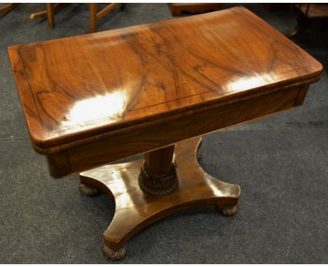 A Goncalo Alves card table, green baize playing surface, octagonal column, carved socle, quatrefoil base, carved bun feet.