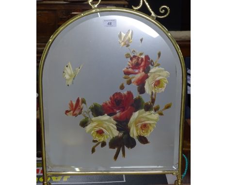 A brass-framed mirrored-glass fire screen, with painted floral design