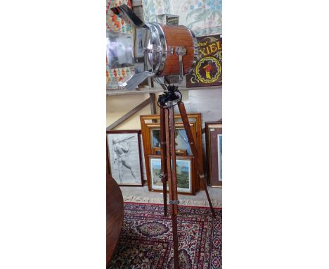 A contemporary teak and chrome searchlight lamp, on tripod stand with chrome fittings