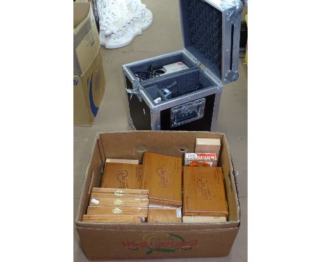 A cased projector and a quantity of cigar boxes