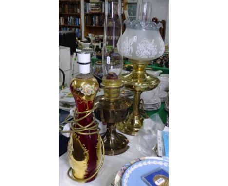 2 brass oil lamps, and a gilded Red Glass table lamp