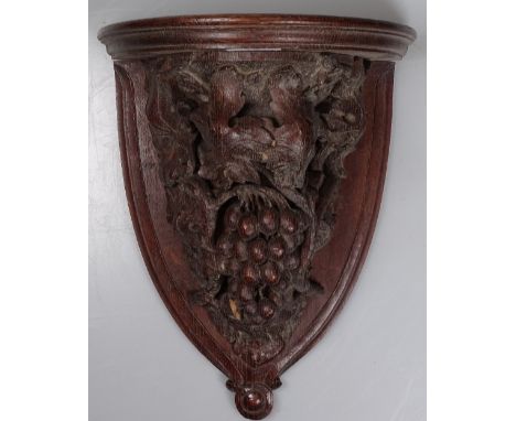 An Antique carved oak clock bracket, with grapes and vine decoration, height 13.5"