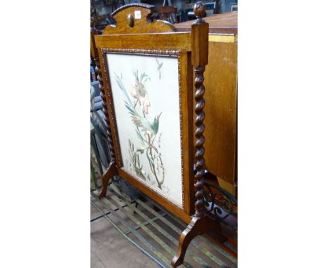 An Edwardian oak firescreen, with inset silk work panel