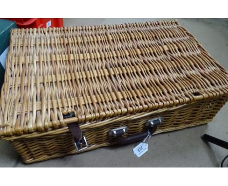 A wicker picnic hamper and a small wicker laundry basket