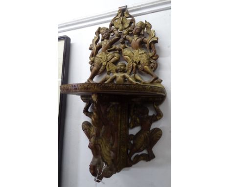An Eastern carved and gilded wood wall bracket