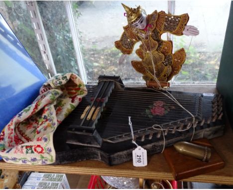 A zither, a sampler, a puppet and paperweight