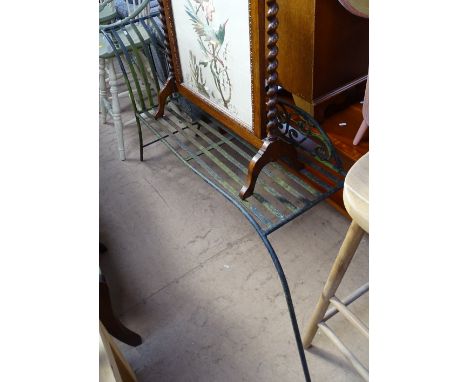 A weathered wrought-iron garden bench