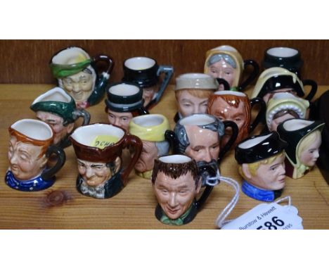 Royal Doulton miniature character jugs depicting Dickens figures with boxes, with display shelf