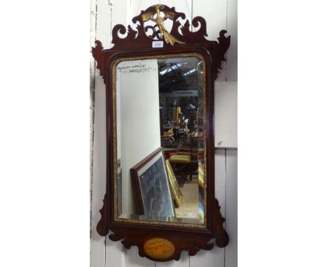 A George III mahogany wall mirror, with eagle pediment